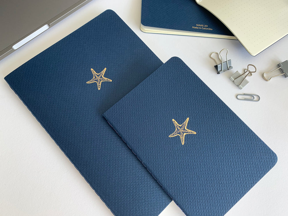 A5 SIZE AND B6 SIZENOTEBOOK STARFISH NOTES GOLD FOILED COVER DETAIL, CARDBOARD COVER COLOR BLUE, INTERIOR DOTTED, ROUNDED CORNERS, VISIBLE SINGER STITCHING ON THE SPINE, INTERIOR PAPER IVORY-COLORED 90 GMS, ACID FREE PAPER MADE IN COLOMBIA BY MAKE2D
