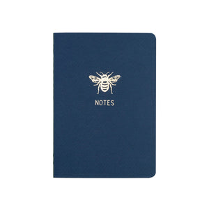 A6 POCKET SIZE NOTEBOOK BEE NOTES GOLD FOILED COVER DETAIL, CARDBOARD COVER COLOR BLUE, INTERIOR DOTTED OR RULED, ROUNDED CORNERS, VISIBLE SINGER STITCHING ON THE SPINE, INTERIOR PAPER IVORY-COLORED 90 GMS, ACID FREE PAPER MADE IN COLOMBIA BY MAKE2D