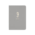 A6 POCKET SIZE NOTEBOOK SEAHORSE NOTES GOLD FOILED COVER DETAIL, CARDBOARD COVER COLOR WHITE, INTERIOR DOTTED OR RULED, ROUNDED CORNERS, VISIBLE SINGER STITCHING ON THE SPINE, INTERIOR PAPER IVORY-COLORED 90 GMS, ACID FREE PAPER MADE IN COLOMBIA BY MAKE2D
