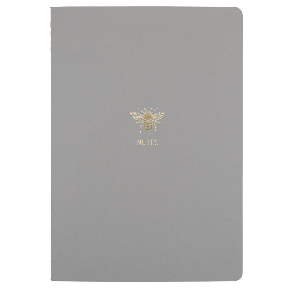 B5 SIZE NOTEBOOK BEE NOTES GOLD FOILED COVER DETAIL, CARDBOARD COVER COLOR GREY INTERIOR DOTTED OR RULED, ROUNDED CORNERS, VISIBLE SINGER STITCHING ON THE SPINE, INTERIOR PAPER IVORY-COLORED 90 GMS, ACID FREE PAPER MADE IN COLOMBIA BY MAKE2D