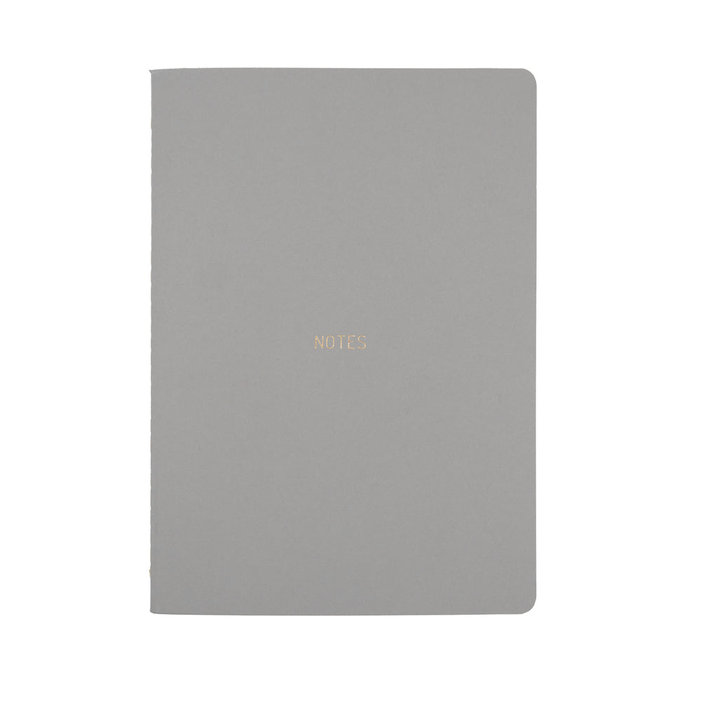 
                
                    Load image into Gallery viewer, A5 SIZE NOTEBOOK NOTES FOILED COVER DETAIL, CARDBOARD COVER COLOR SMOKE GREY, INTERIOR DOTTED, ROUNDED CORNERS, VISIBLE SINGER STITCHING ON THE SPINE, INTERIOR PAPER IVORY-COLORED 90 GMS, ACID FREE PAPER MADE IN COLOMBIA BY MAKE2D
                
            
