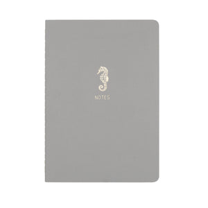 A5 SIZE NOTEBOOK SEAHORSE NOTES FOILED COVER DETAIL, CARDBOARD COVER COLOR SMOKE GREY, INTERIOR DOTTED, ROUNDED CORNERS, VISIBLE SINGER STITCHING ON THE SPINE, INTERIOR PAPER IVORY-COLORED 90 GMS, ACID FREE PAPER MADE IN COLOMBIA BY MAKE2D