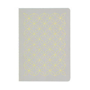 A5  SIZE NOTEBOOK EMBOROIDERED TOKYO COVER DETAIL, CARDBOARD COVER COLOR GREY, YELLOW EMBROIDERY, INTERIOR DOTTED OR RULED, ROUNDED CORNERS, VISIBLE SINGER STITCHING ON THE SPINE, INTERIOR PAPER IVORY-COLORED 90 GMS, ACID FREE PAPER BACK GOLD FOIL COVER DETAIL MADE IN COLOMBIA BY MAKE2D