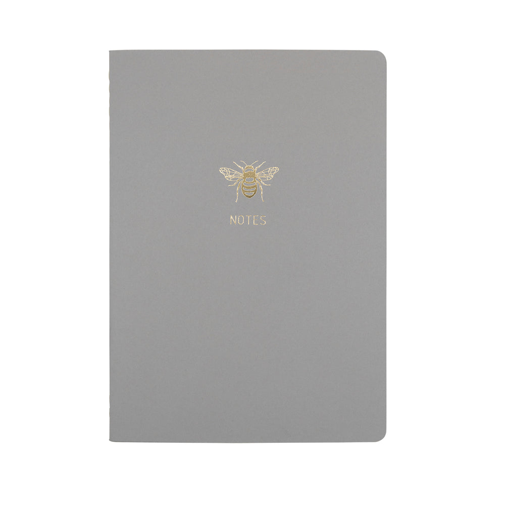 A5 SIZE NOTEBOOK GOLD FOILED COVER DETAIL BEE NOTES, CARDBOARD COVER COLOR SMOKE GREY INTERIOR DOTTED OR RULED, ROUNDED CORNERS, VISIBLE SINGER STITCHING ON THE SPINE, INTERIOR PAPER IVORY-COLORED 90 GMS, ACID FREE PAPER BY MAKE2D