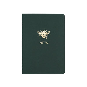 A6 POCKET SIZE NOTEBOOK BEE NOTES GOLD FOILED COVER DETAIL, CARDBOARD COVER COLOR GREEN, INTERIOR DOTTED OR RULED, ROUNDED CORNERS, VISIBLE SINGER STITCHING ON THE SPINE, INTERIOR PAPER IVORY-COLORED 90 GMS, ACID FREE PAPER MADE IN COLOMBIA BY MAKE2D