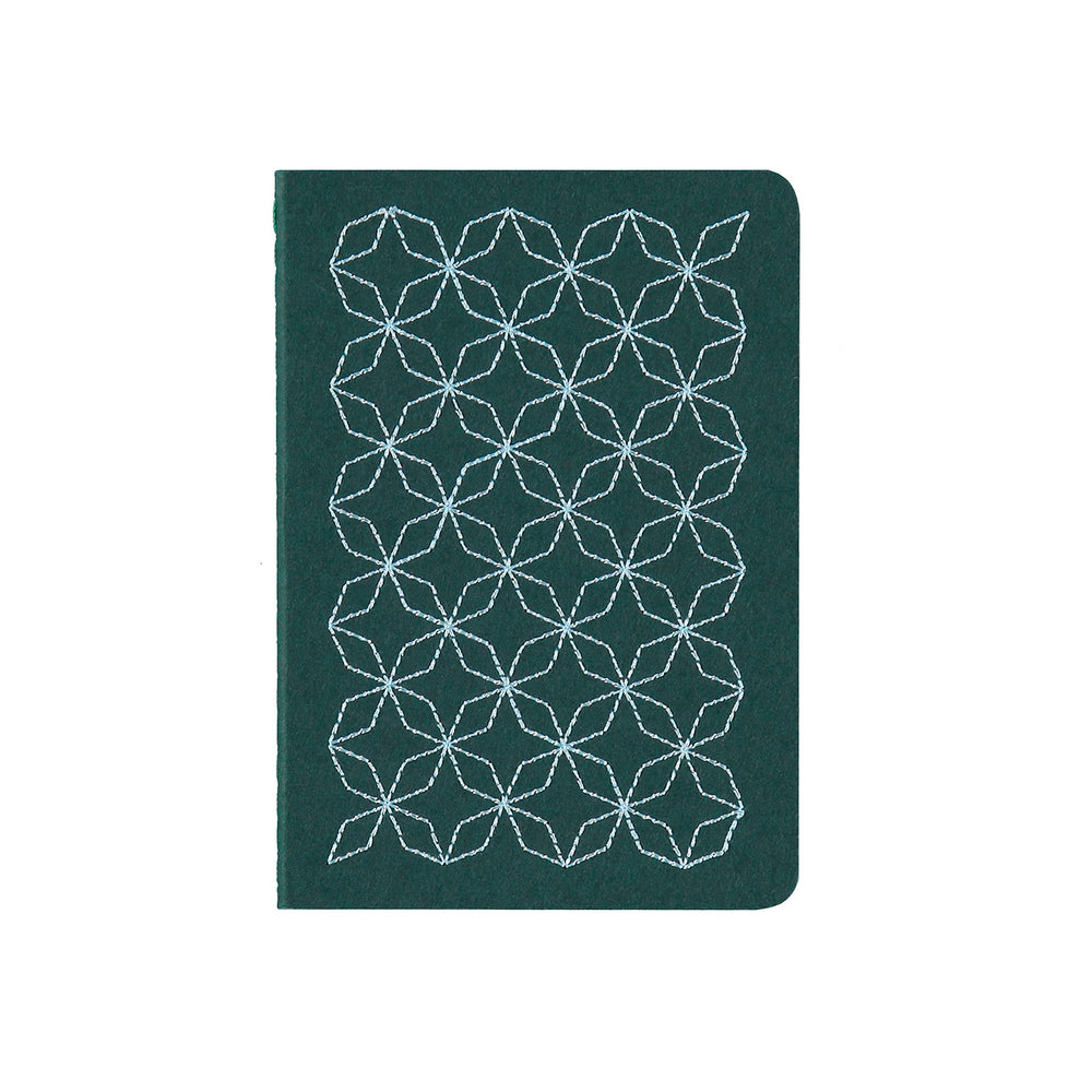 A6 POCKET SIZE NOTEBOOK EMBOROIDERED TOKYO COVER DETAIL, CARDBOARD COVER COLOR GREEN, SKY BLUE EMBROIDERY, INTERIOR DOTTED OR RULED, ROUNDED CORNERS, VISIBLE SINGER STITCHING ON THE SPINE, INTERIOR PAPER IVORY-COLORED 90 GMS, ACID FREE PAPER BACK GOLD FOIL COVER DETAIL MADE IN COLOMBIA BY MAKE2D