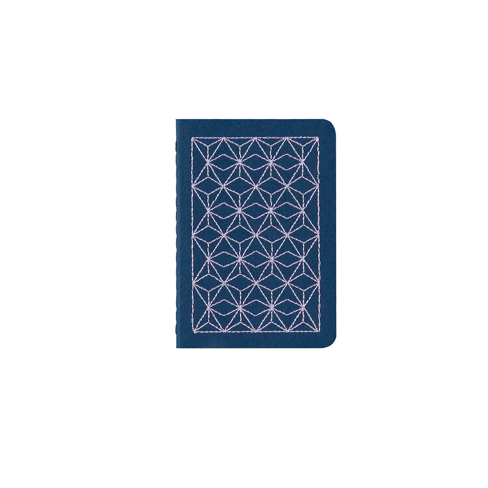 
                
                    Load image into Gallery viewer, B7 MINI POCKET SIZE NOTEBOOK LILAC EMBROIDERED COVER DETAIL, CARDBOARD COVER COLOR BLUE, INTERIOR DOTTED, ROUNDED CORNERS, VISIBLE SINGER STITCHING ON THE SPINE, INTERIOR PAPER IVORY-COLORED 90 GMS, ACID FREE PAPER BY MAKE2D
                
            